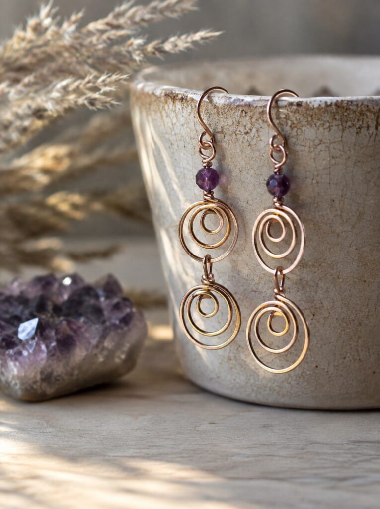 Copper wire earrings with purple amethyst beads and spiral wrapped loops.