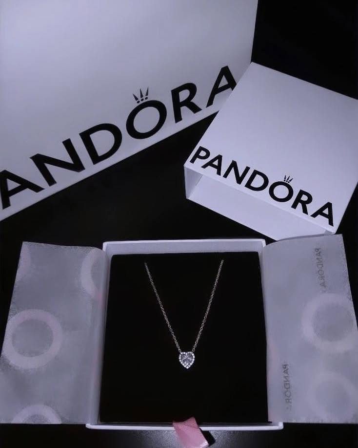 Silver heart pendant necklace in a Pandora jewelry box with branded packaging.
