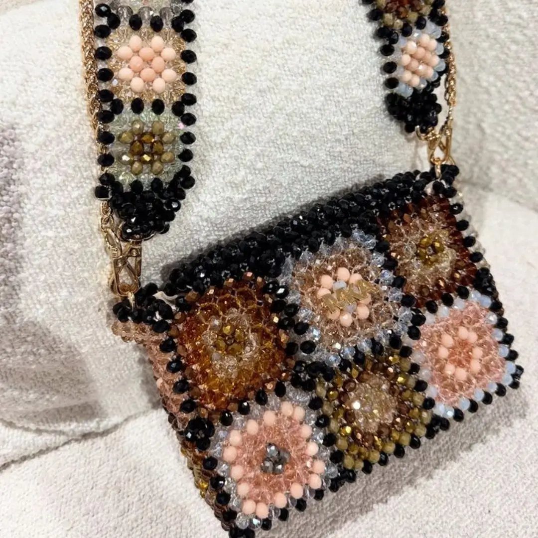 Beaded handbag and strap with floral patterns in peach, gold, and black beads.